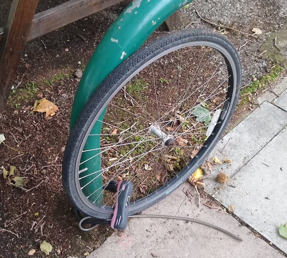 a photo of solitary wheel left behind after the rest of the bike was nicked